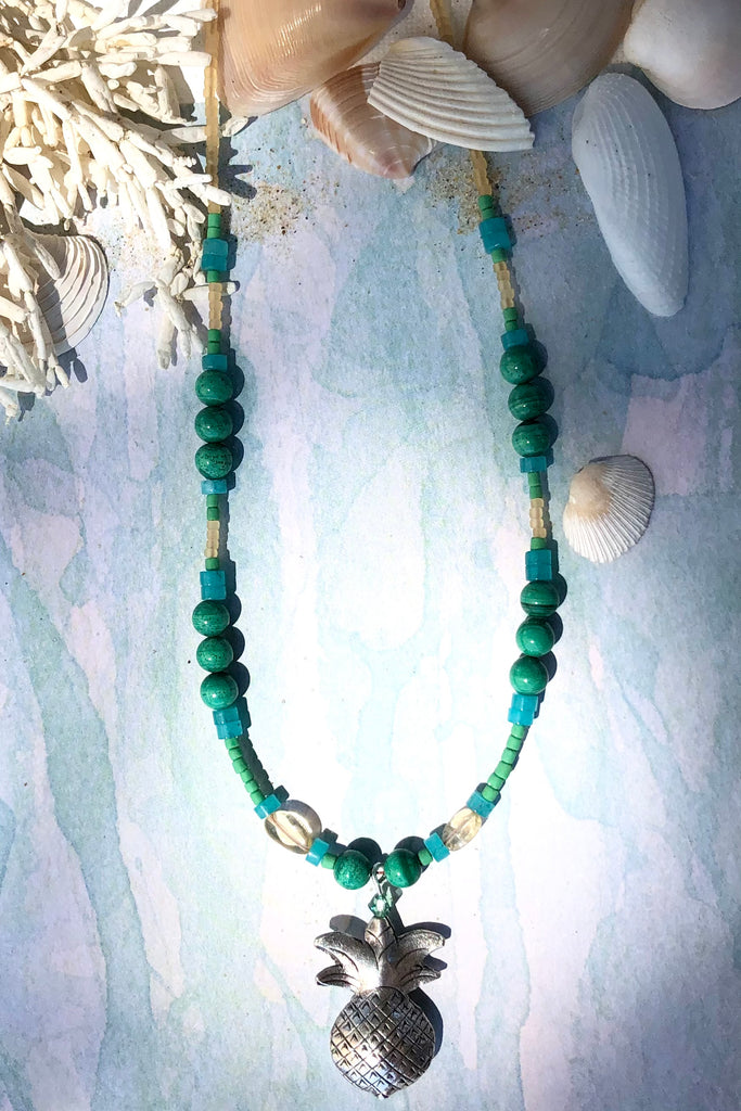 This necklace Sunny Coast inspired one off piece was made in our Noosa Studio,  There is a Thai silver pineapple as the central focus, the beads are the green, gold and turquoise of the area.