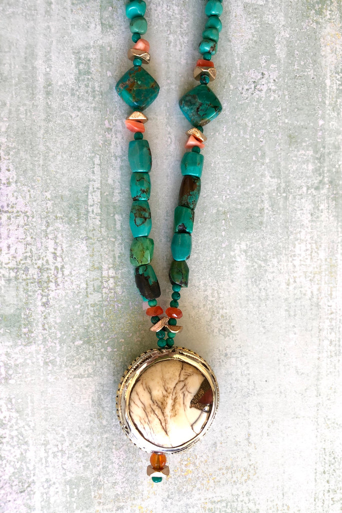 The centre piece is an inlaid Naga conch shell bead from Tibet. The beads are all genuine natural Turquoise, very irregular and some are very old.
