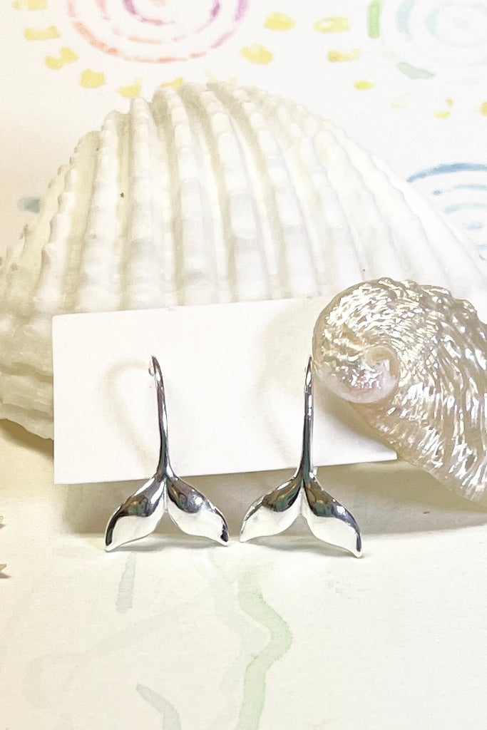 Silver earring whale tail.