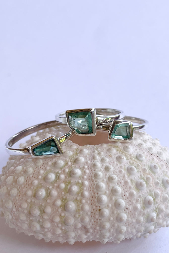 This pale blue green natural tourmaline has been cut in an elegant free form geometric style, then set to fit its unique lines and brilliant colours creating a one of a kind piece. 