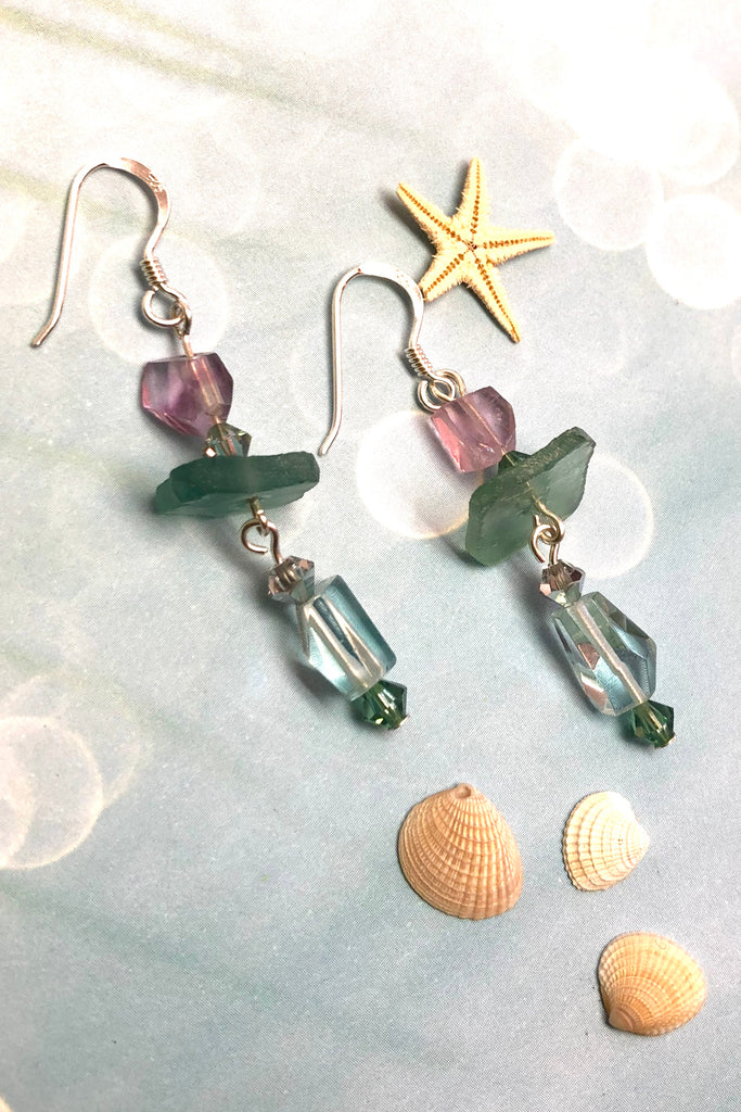 Hand cut antique glass set off with pale aqua Fluorite and swarovski crystal beads.