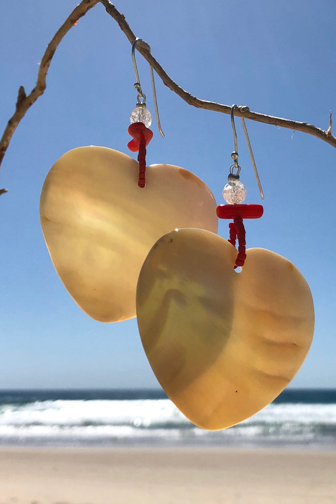 The polished Mother of Pearl shell has been hand cut into a heart shape then polished. The detal is of Red Bamboo coral, crackle rock crystal and handmade sand beads, the hook is silver.