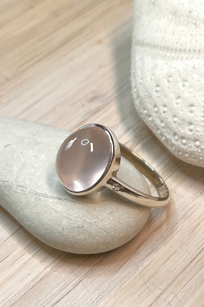 A beautiful feminine, pale luminous pink Rose Quartz  gemstone ring, this darling and dainty little ring has a tiny genuine diamond set into the band on each side of the centre stone.