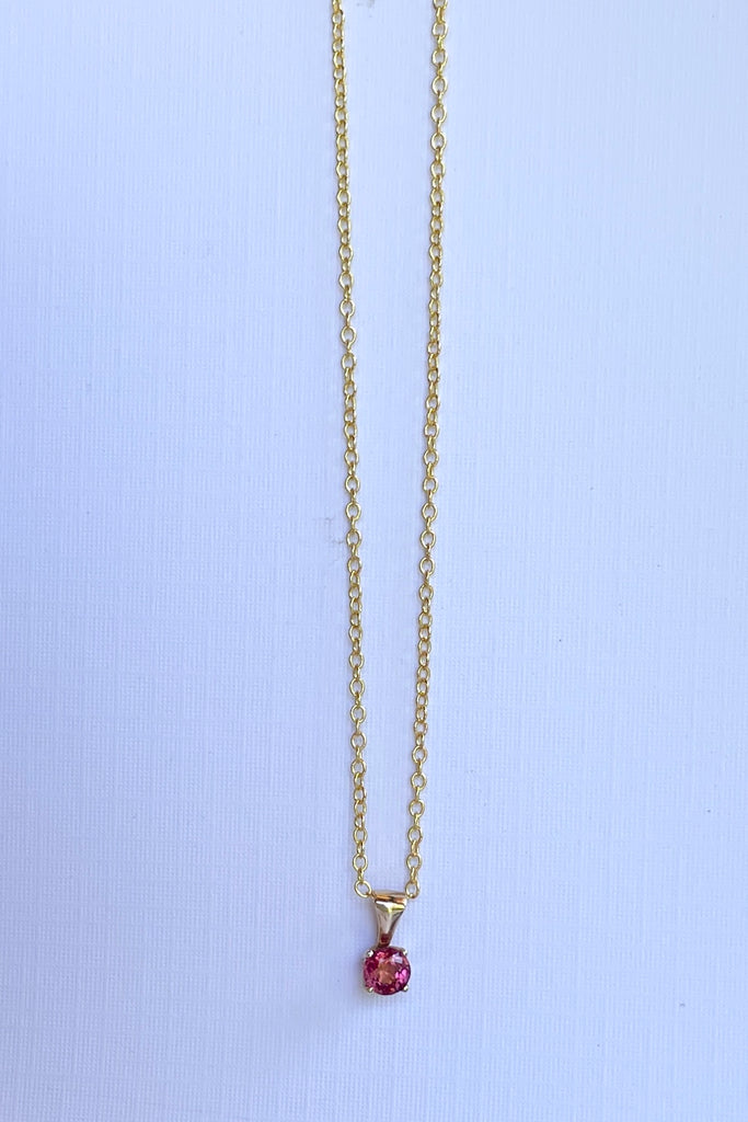 This adorable Luna pendant is made in 9ct gold, the stone is a lovely dark pink 4mm Tourmaline gemstone. A tiny delicate and sophisticated gemstone pendant.