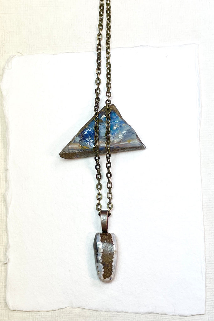  The pendant has a band of rock running down the centre and the edges have a crystalline opal edge.