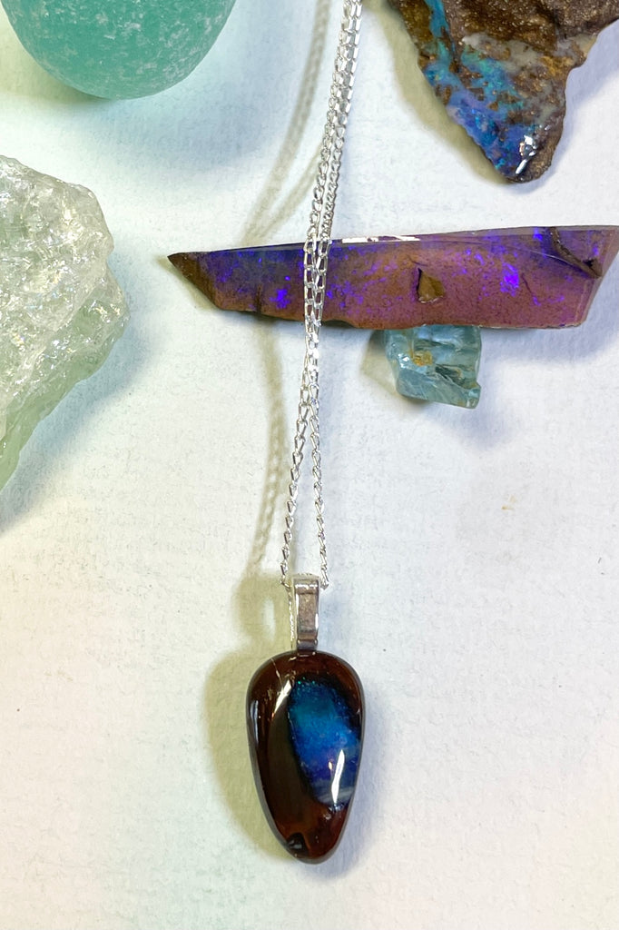 This tiny opal pendant has a gorgeous pond of deep blue flash in the centre.