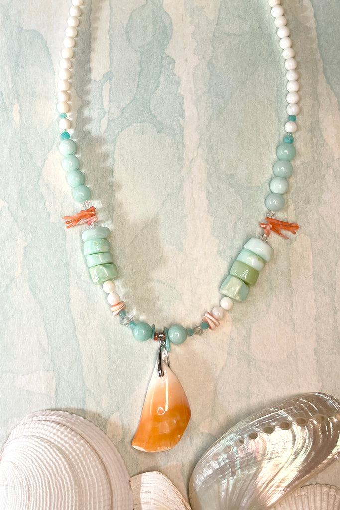The centre piece is cut from a shard of sea shell fossicked on the beach in Vanuatu. The necklace is just so special, the design is original, to flatter and enhance the centre shell pendant, and give a feeling of the water and cool of the South Pacific. The beads include four Herkimer diamonds, eight large paillette cut Peruvian opal stones, also pink coral, Amazonite, quartz and shell.