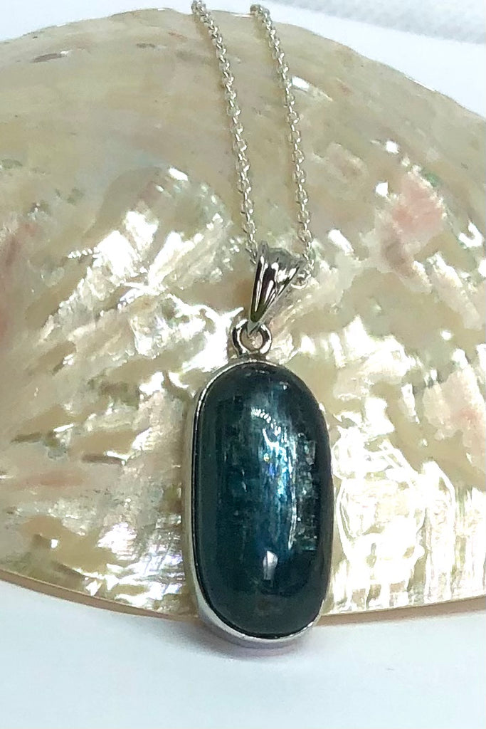  this stone is a greenish grey blue with silvery flashes. It is clear sea green when held to the light, cut to a lovely high dome oval cabochon.