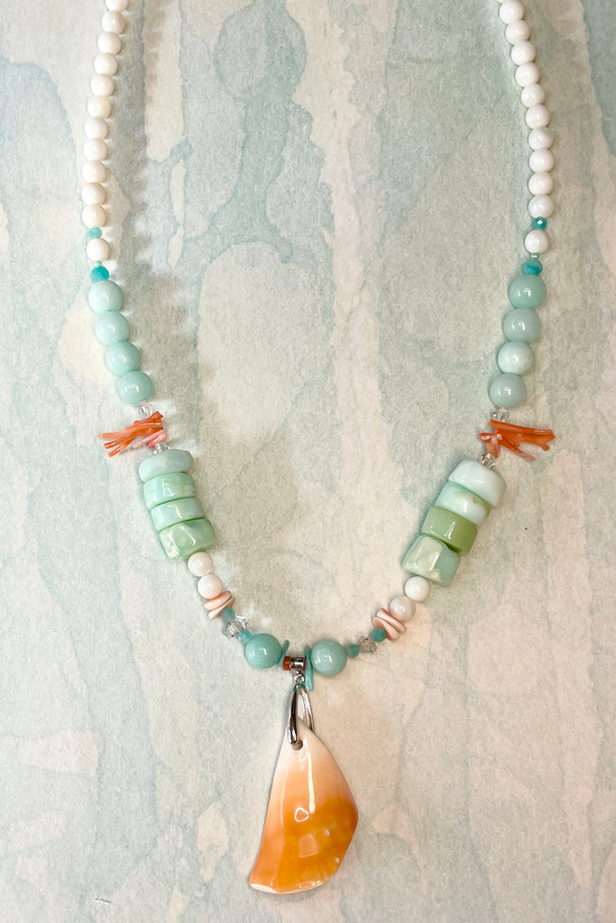 The centre piece is cut from a shard of sea shell fossicked on the beach in Vanuatu. The necklace is just so special, the design is original, to flatter and enhance the centre shell pendant, and give a feeling of the water and cool of the South Pacific. The beads include four Herkimer diamonds, eight large paillette cut Peruvian opal stones, also pink coral, Amazonite, quartz and shell.