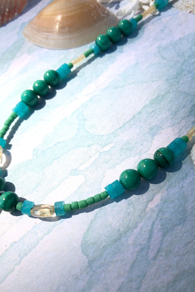 This necklace Sunny Coast inspired one off piece was made in our Noosa Studio,  There is a Thai silver pineapple as the central focus, the beads are the green, gold and turquoise of the area.