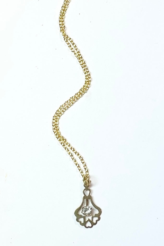 A small silver vintage pendant, flash plated with a diamante centre and a row of hearts at the base.