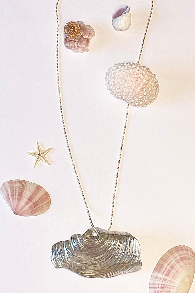 The centre piece is solid silver, it is a cast from a shell found on the Noosa North Shore. The necklace is just so special, the design is original as it is cast directly from the shell. The back of the piece is beautifully inscribed with a pattern of bubbles and waves.