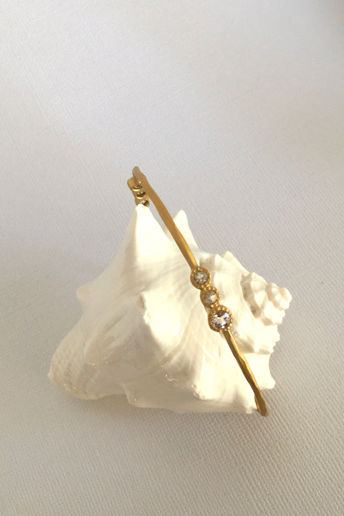 This adorable bangle has Starry luna appeal it is handcrafted in gold plated  silver vermeil. The gems are studded in sets of three and will sparkle at different angles