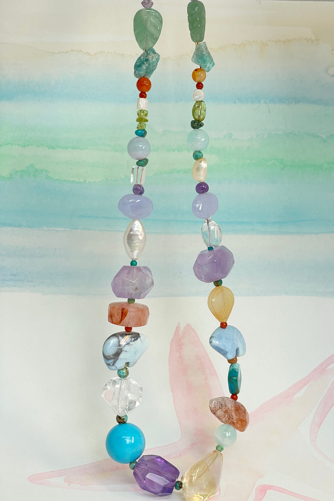 The necklace features two hand carved Zuni bears bought in Tucson Arizona. Stones are Natural Turquoise, Pearl, Amethyst, Carnelian, Clear Rock Crystal Blue Lace Agate,. Citrine, Mother of Pearl shell, Strawberry Quartz and Peridot. 