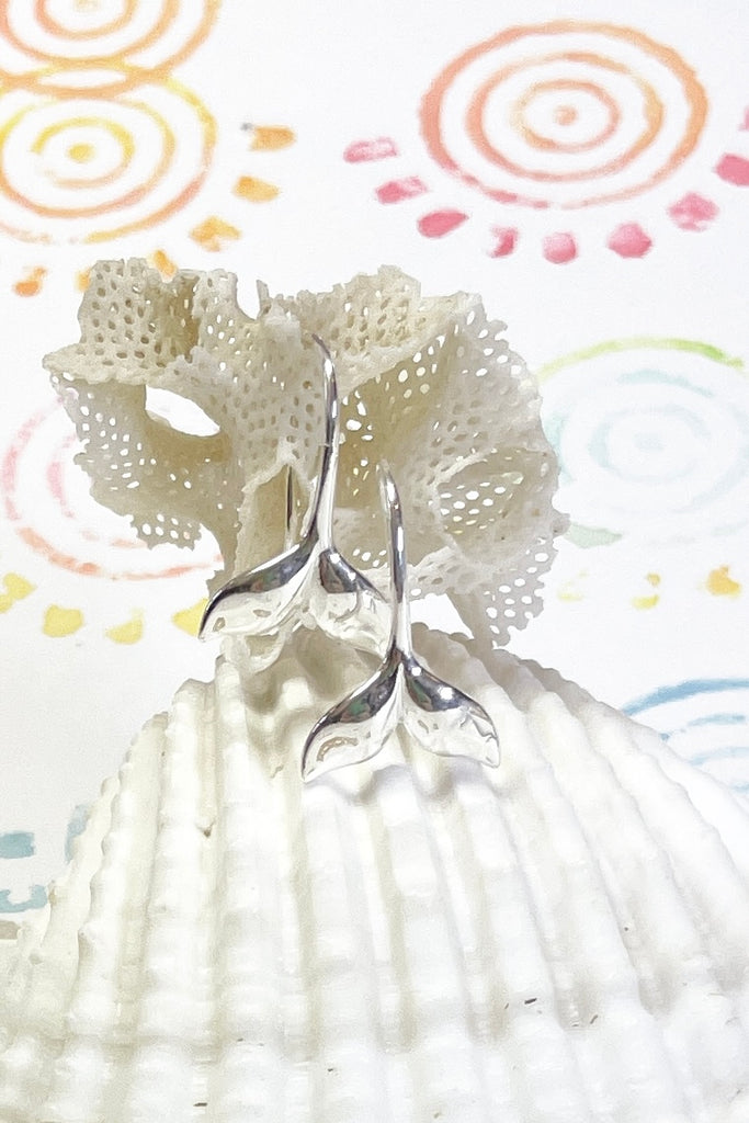 Silver earring whale tail.