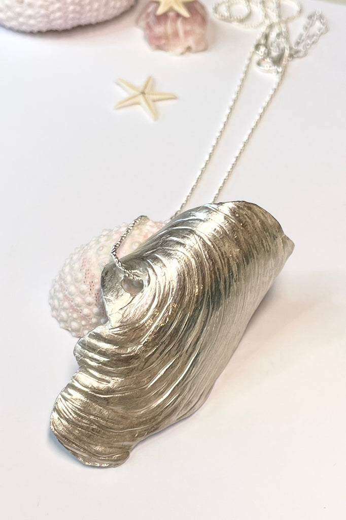 The centre piece is solid silver, it is a cast from a shell found on the Noosa North Shore. The necklace is just so special, the design is original as it is cast directly from the shell. The back of the piece is beautifully inscribed with a pattern of bubbles and waves.