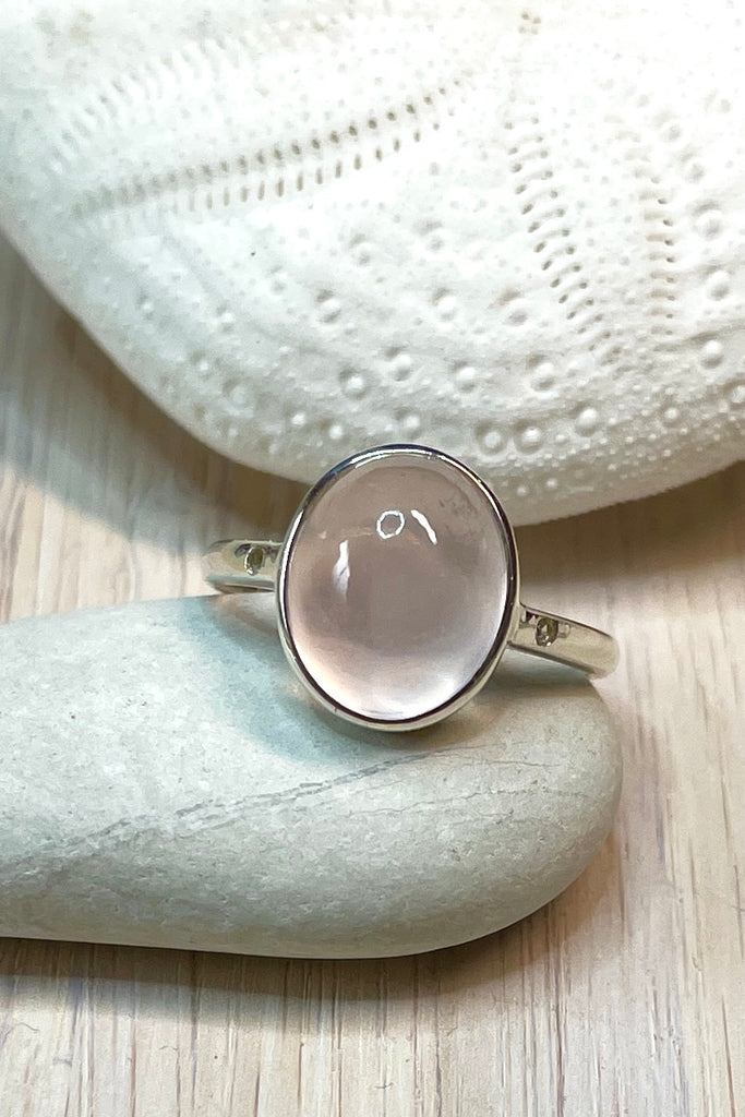 A beautiful feminine, pale luminous pink Rose Quartz  gemstone ring, this darling and dainty little ring has a tiny genuine diamond set into the band on each side of the centre stone.