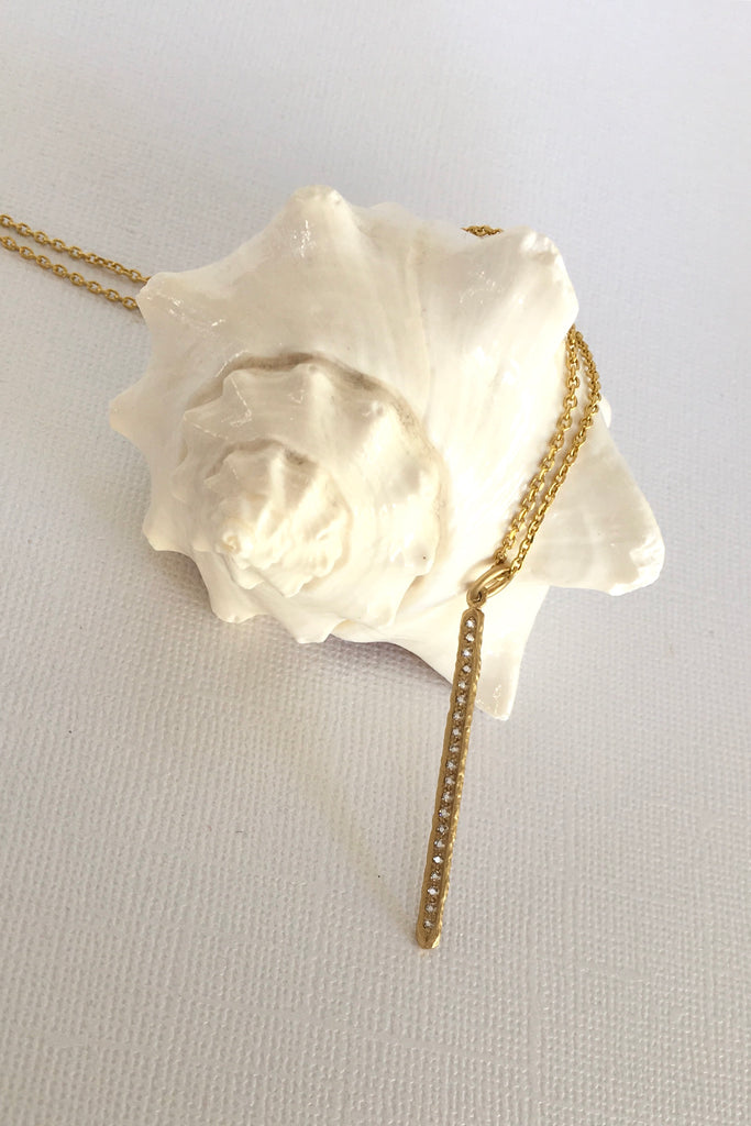 Made in gold vermeil and tiny sparkling white topaz gemstones, the finish is quiet and naturalistic, the surface is matte. 
