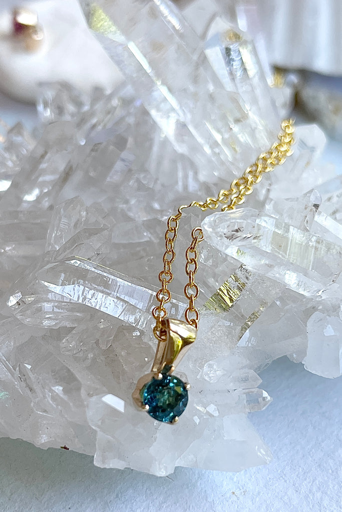 This adorable Luna pendant is made in 9ct white gold, the stone is a lovely clear bright teal 3mm Tourmaline gemstone. A tiny delicate and sophisticated gemstone pendant.