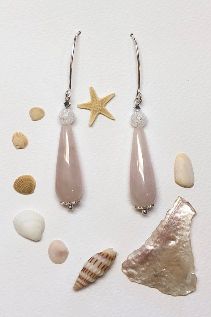 Approximately 6cm length.  Drop style earrings. 925 silver hook earrings. Pale pink Rose quartz teardrop shaped stone with a single crackle rock crystal bead on top.