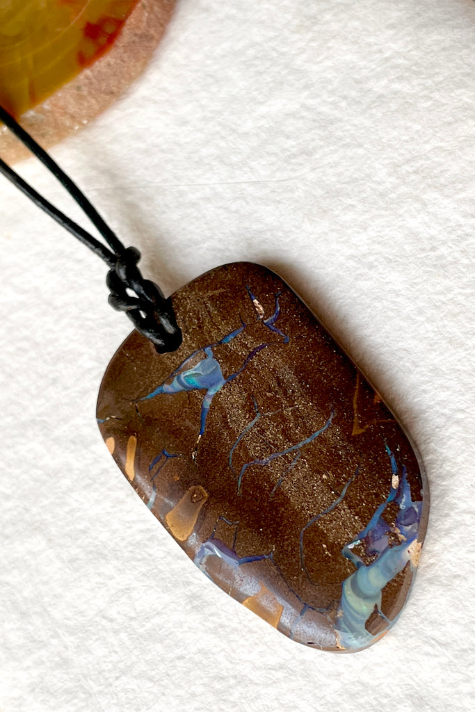  The opal pendant is cut as a freeform rectangle, the colours and rock formations of the material from which it was cut are so beautiful, a secret to the past of the country Australia.  