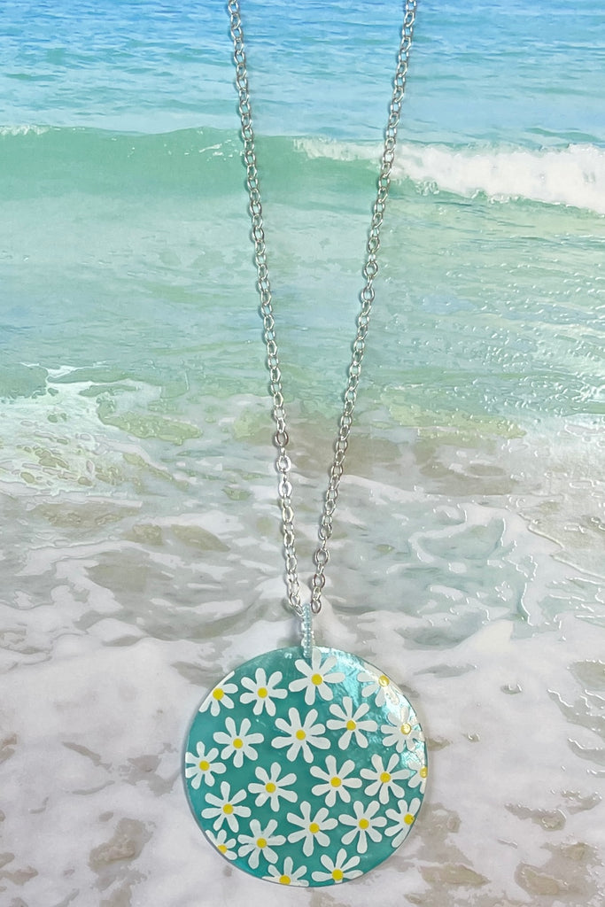 sweetheart daisy necklace is a Capiz shell circle hand painted with 60's style daisies