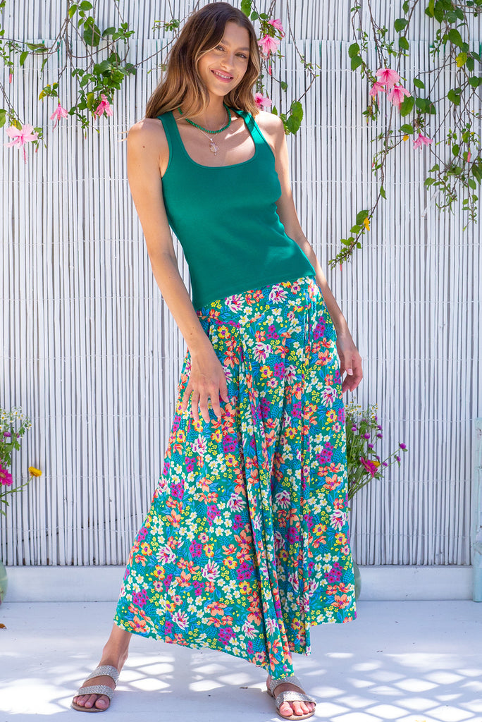The Atlantis Gone Green Maxi Skirt is a gorgeous green based skirt with a medium sized, multicoloured floral print. he skirt features a double v-shaped waist yoke, inset panels on the front from the yoke down, very full skirt, elasticated back of waist and side pockets. This is a slip on design with a shapely hemline and slightly longer front due to the inset panels. Made from 100% Viscose.