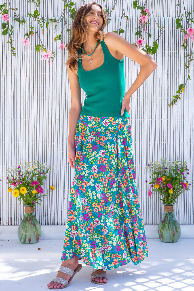 The Atlantis Gone Green Maxi Skirt is a gorgeous green based skirt with a medium sized, multicoloured floral print. he skirt features a double v-shaped waist yoke, inset panels on the front from the yoke down, very full skirt, elasticated back of waist and side pockets. This is a slip on design with a shapely hemline and slightly longer front due to the inset panels. Made from 100% Viscose.