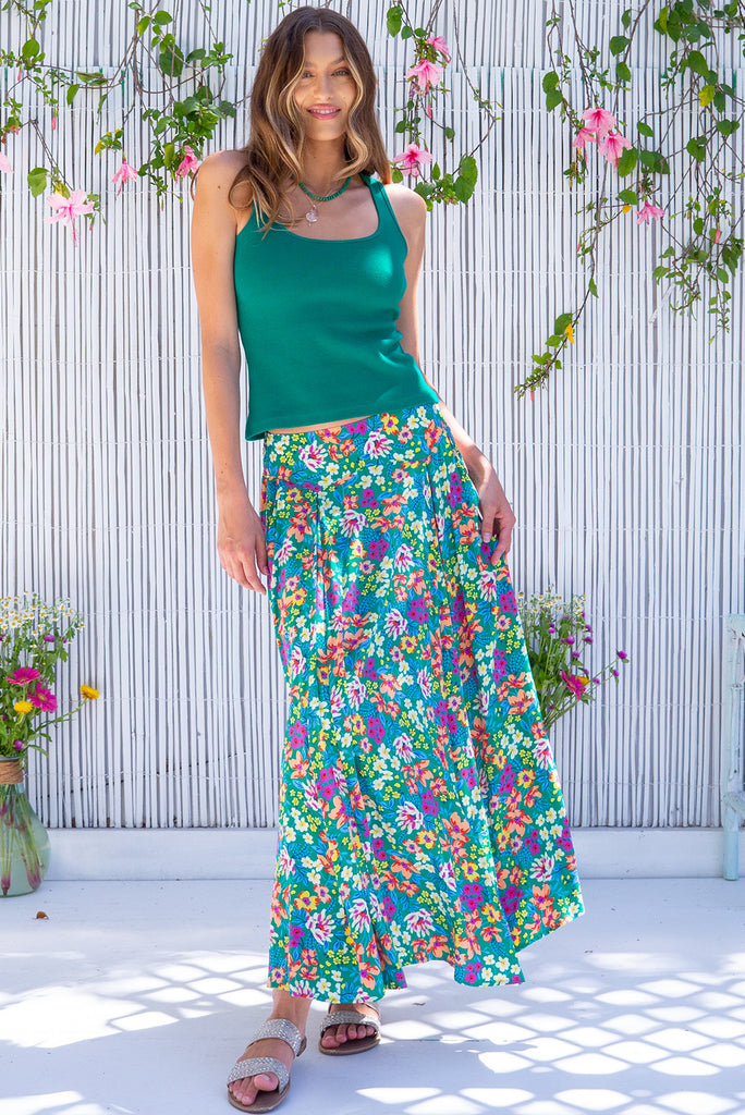 The Atlantis Gone Green Maxi Skirt is a gorgeous green based skirt with a medium sized, multicoloured floral print. he skirt features a double v-shaped waist yoke, inset panels on the front from the yoke down, very full skirt, elasticated back of waist and side pockets. This is a slip on design with a shapely hemline and slightly longer front due to the inset panels. Made from 100% Viscose.