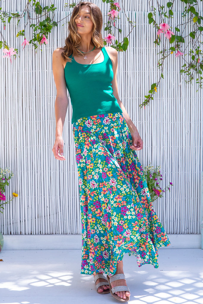 The Atlantis Gone Green Maxi Skirt is a gorgeous green based skirt with a medium sized, multicoloured floral print. he skirt features a double v-shaped waist yoke, inset panels on the front from the yoke down, very full skirt, elasticated back of waist and side pockets. This is a slip on design with a shapely hemline and slightly longer front due to the inset panels. Made from 100% Viscose.