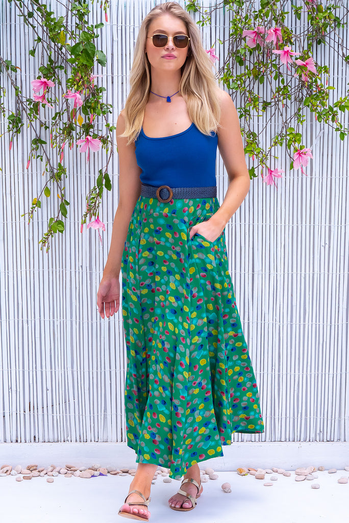 The Atlantis Jade Green Maxi Skirt is a gorgeous skirt with a jade green base and multicoloured spot print. The skirt features a double v-shaped waist yoke, inset panels on the front from the yoke down, very full skirt, elasticated back of waist and side pockets. This is a slip on design with a shapely hemline and slightly longer front due to the inset panels. Made from 100% Viscose.