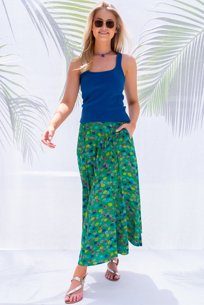 The Atlantis Jade Green Maxi Skirt is a gorgeous skirt with a jade green base and multicoloured spot print. The skirt features a double v-shaped waist yoke, inset panels on the front from the yoke down, very full skirt, elasticated back of waist and side pockets. This is a slip on design with a shapely hemline and slightly longer front due to the inset panels. Made from 100% Viscose.