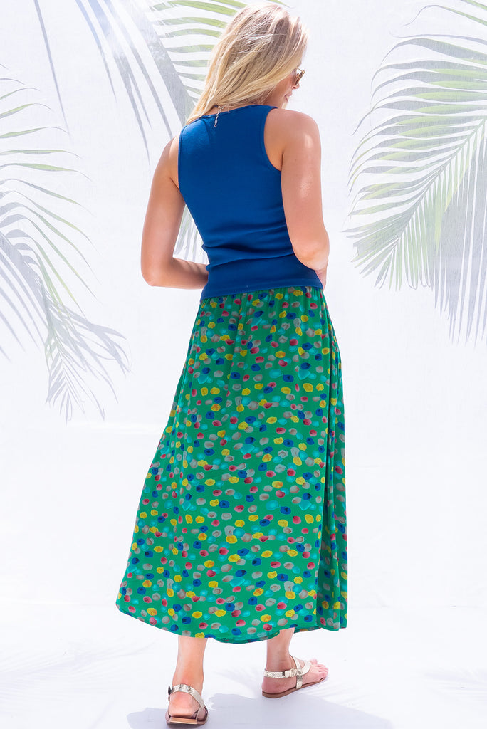 The Atlantis Jade Green Maxi Skirt is a gorgeous skirt with a jade green base and multicoloured spot print. The skirt features a double v-shaped waist yoke, inset panels on the front from the yoke down, very full skirt, elasticated back of waist and side pockets. This is a slip on design with a shapely hemline and slightly longer front due to the inset panels. Made from 100% Viscose.