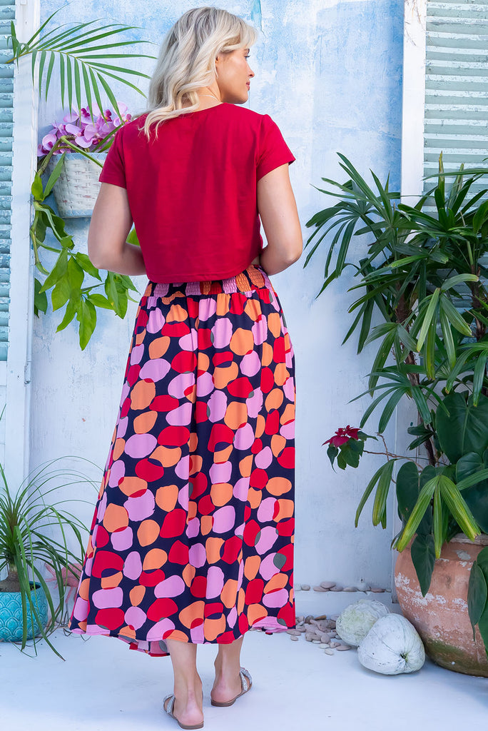 The Atlantis Zinzi Spot Maxi Skirt features double V-shaped waist yoke, side pockets and 100% viscose in ink base with pink, orange and red spots.