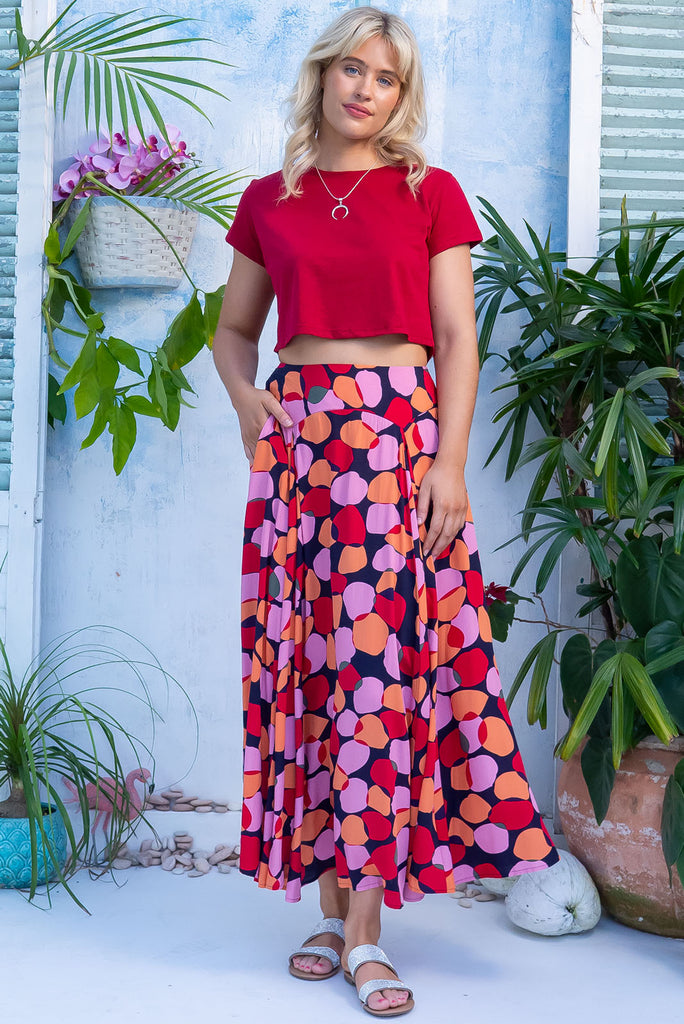 The Atlantis Zinzi Spot Maxi Skirt features double V-shaped waist yoke, side pockets and 100% viscose in ink base with pink, orange and red spots.
