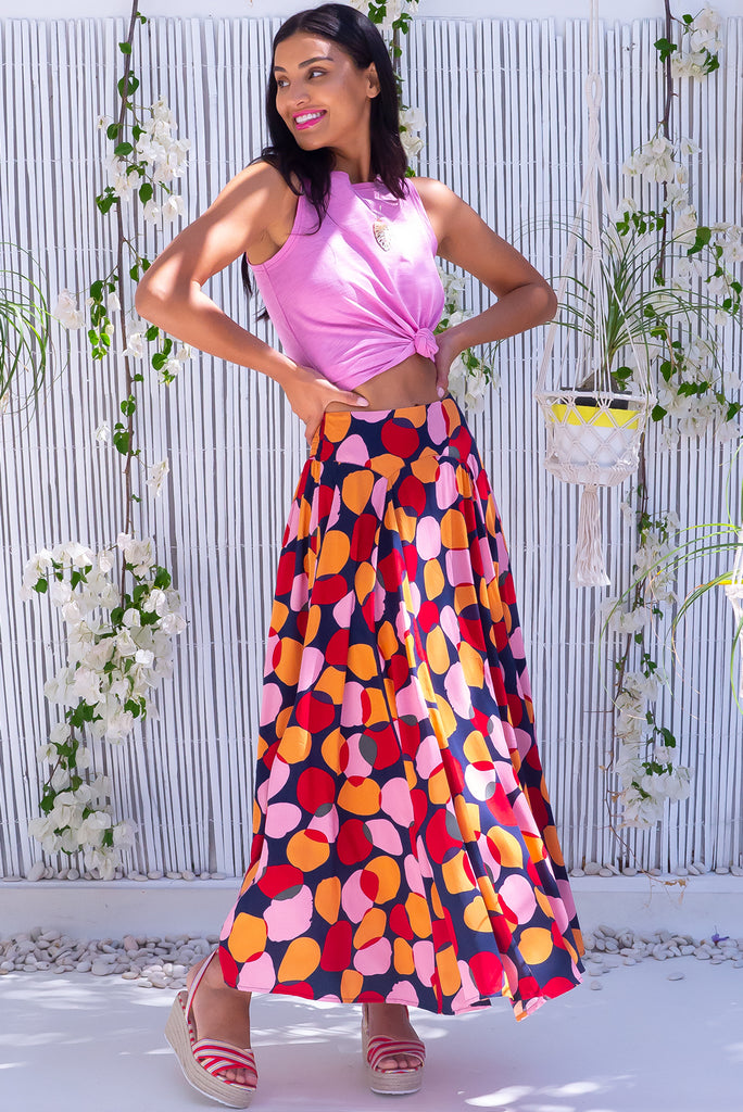The Atlantis Zinzi Spot Maxi Skirt features double V-shaped waist yoke, side pockets and 100% viscose in ink base with pink, orange and red spots.