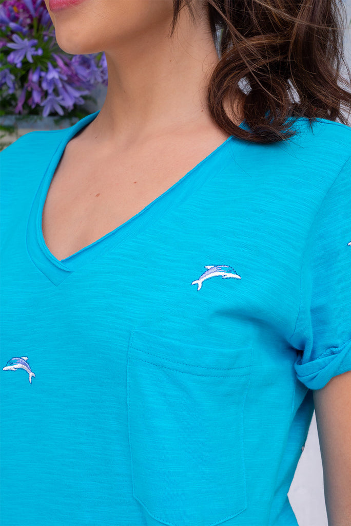 The Aurora T-Shirt Blue Dolphin is a sky blue, relaxed fit, t-shirt with embroidered dolphins all over. The shirt features a raw edged v-neck, front breast pocket, side spilt and rolled sleeve. Made from Knit 100% cotton.