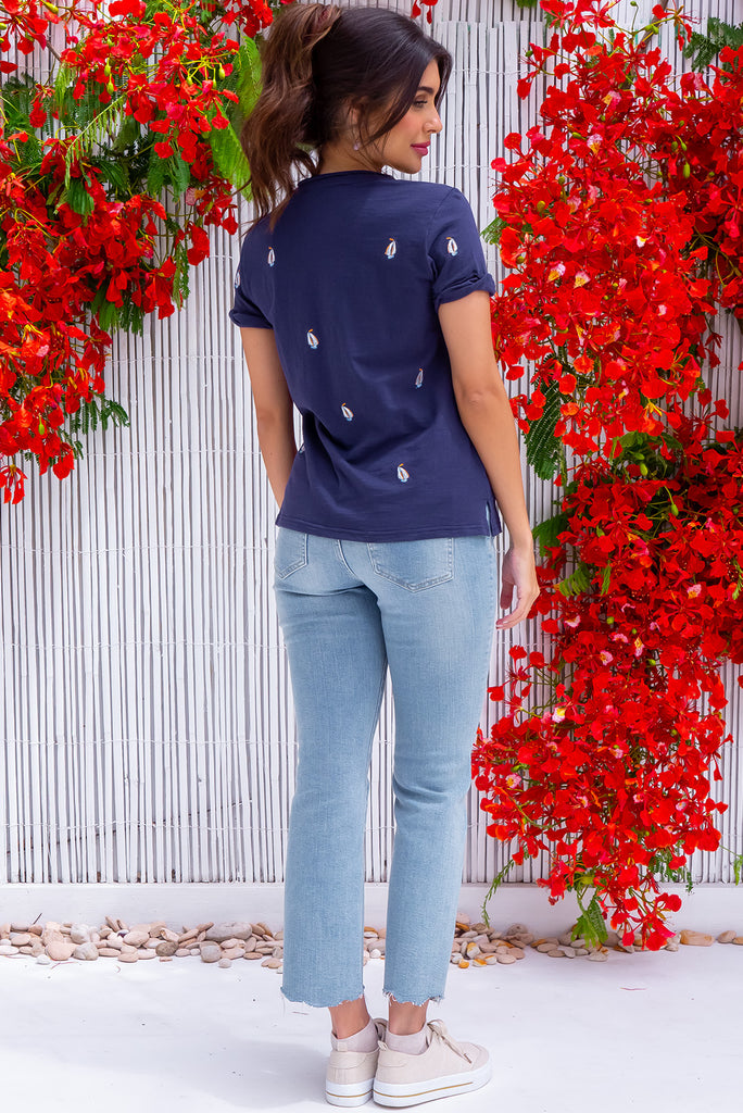 The Aurora T-Shirt Navy Yacht is a navy, relaxed fit, t-shirt with embroidered yachts all over. The shirt features a raw edged v-neck, front breast pocket, side spilt and rolled sleeve. Made from Knit 100% cotton.