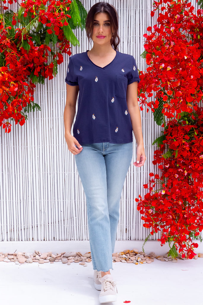 The Aurora T-Shirt Navy Yacht is a navy, relaxed fit, t-shirt with embroidered yachts all over. The shirt features a raw edged v-neck, front breast pocket, side spilt and rolled sleeve. Made from Knit 100% cotton.