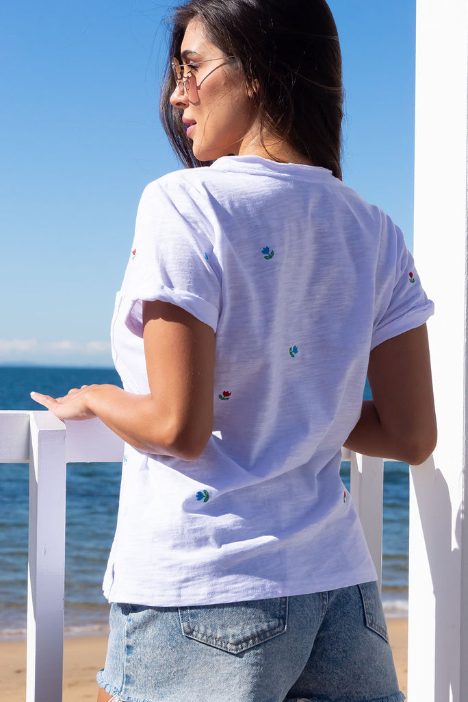 A simple and sweet flower print embroidered on a crisp, white cotton base makes the new Aurora T White Light a fresh alternative to the classic white tee. Knit 95% cotton/ 5% spandex, Lightweight, V-neck, Pocket on bust, Short cuff sleeves, Loose fit.