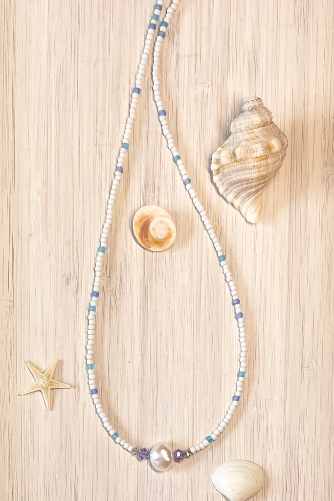  A delicate choker style necklace made with tiny sand seed beads, with a pearl and Swarovski crystal centre piece.