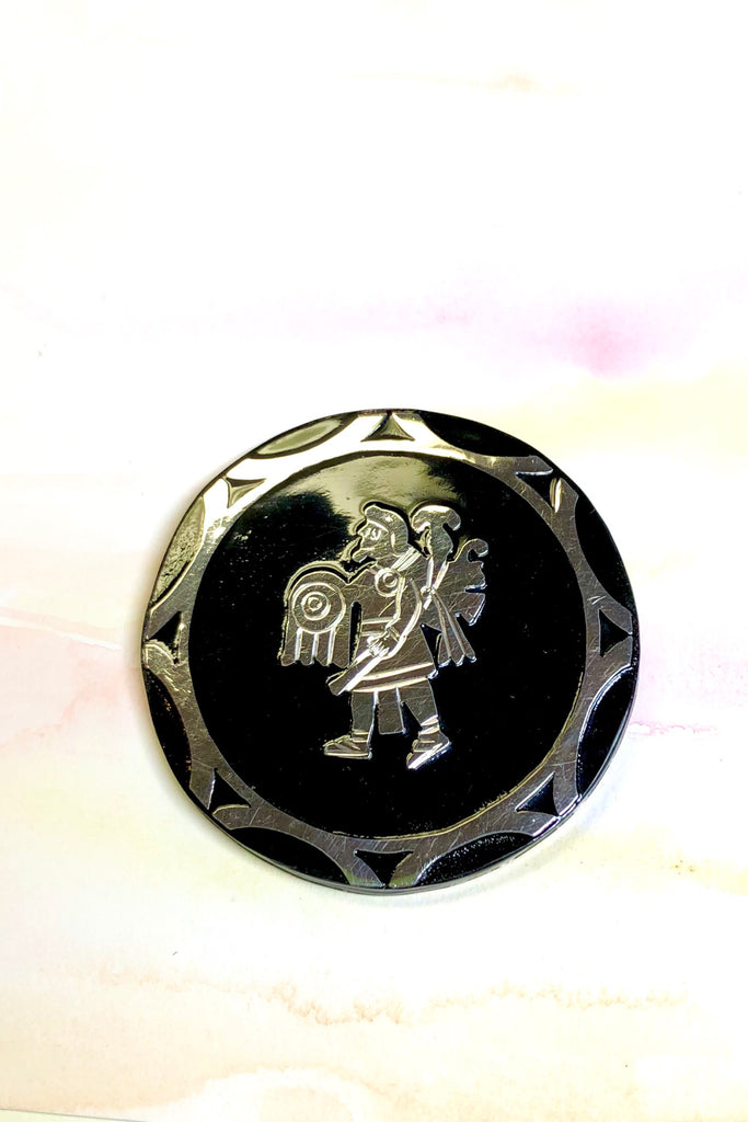 Handmade with silver warrior figure on the front and silver back.