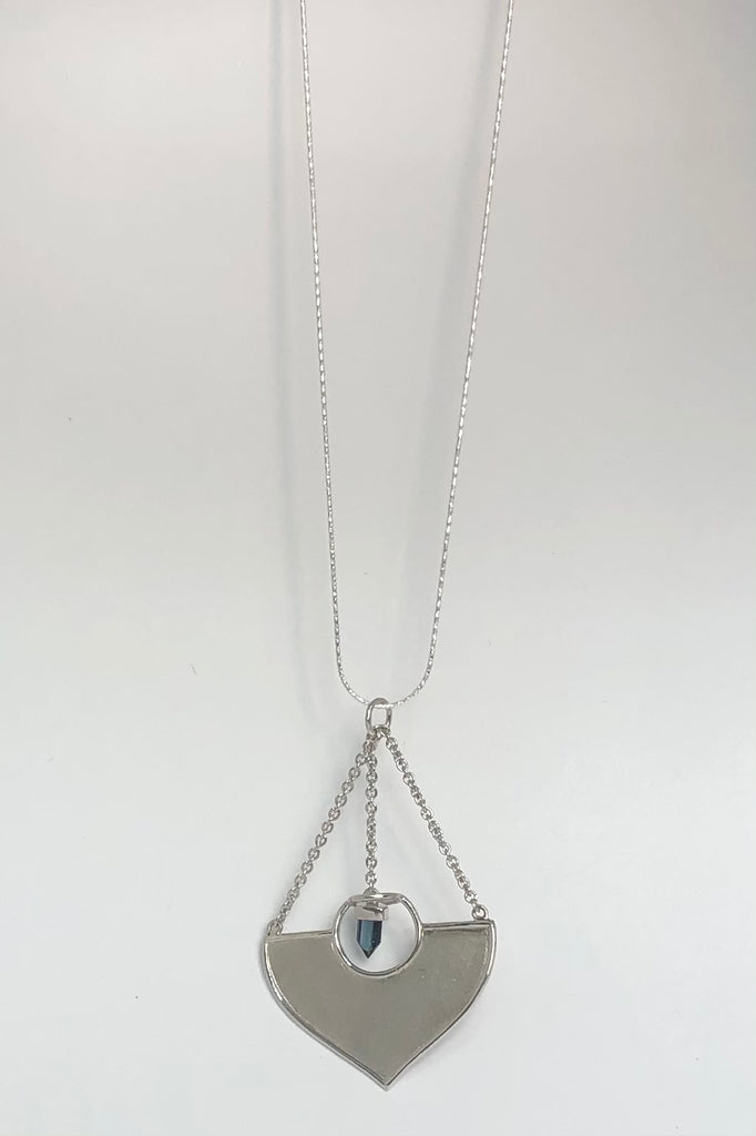 A stunning African Style 925 silver pendant with a Tourmaline Shard which hangs perfectly through a silver circle. The intense blue Tourmaline was sourced ethically from miners in Nigeria,