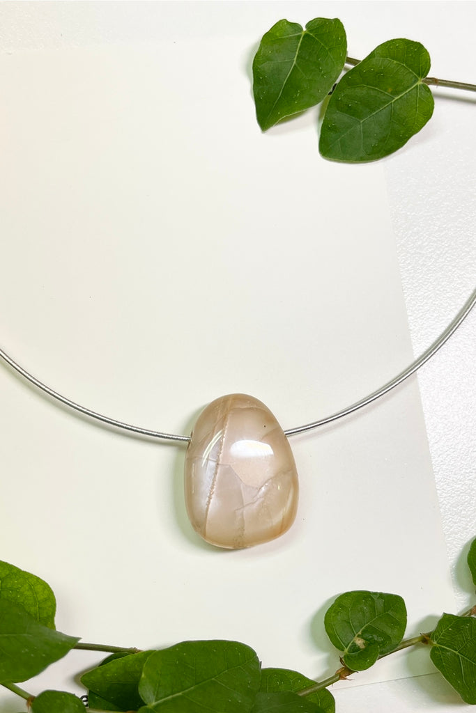 The Pendant is a really lovely luminescent peach moonstone, it hangs from a 925 silver Omega chain. 