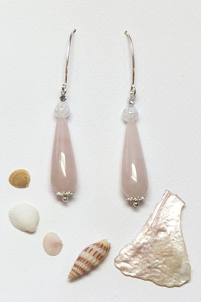Approximately 6cm length.  Drop style earrings. 925 silver hook earrings. Pale pink Rose quartz teardrop shaped stone with a single crackle rock crystal bead on top.