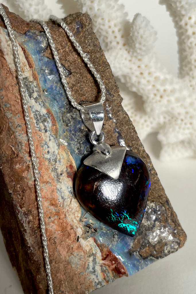  This intriguing and unique piece of opal was cut and polished into the heart shape for Mombasa Rose in Noosa, Queensland. The bright flashes of turquoise, teal and blue colour are very intense and deep in the stone, giving it a flashing twinkling look.  Very beautiful when viewed in sunlight. A very chic and modern opal pendant design. 