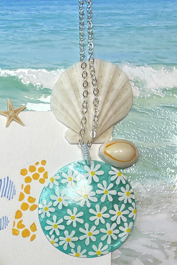 sweetheart daisy necklace is a Capiz shell circle hand painted with 60's style daisies