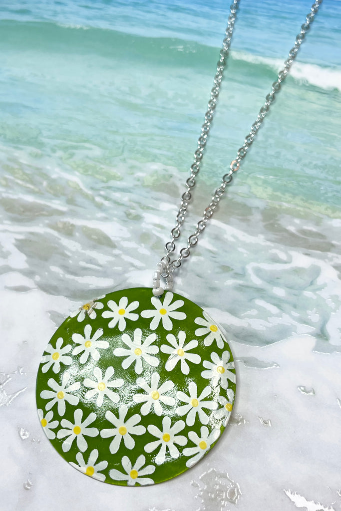 sweetheart daisy necklace is a Capiz shell circle hand painted with 60's style daisies