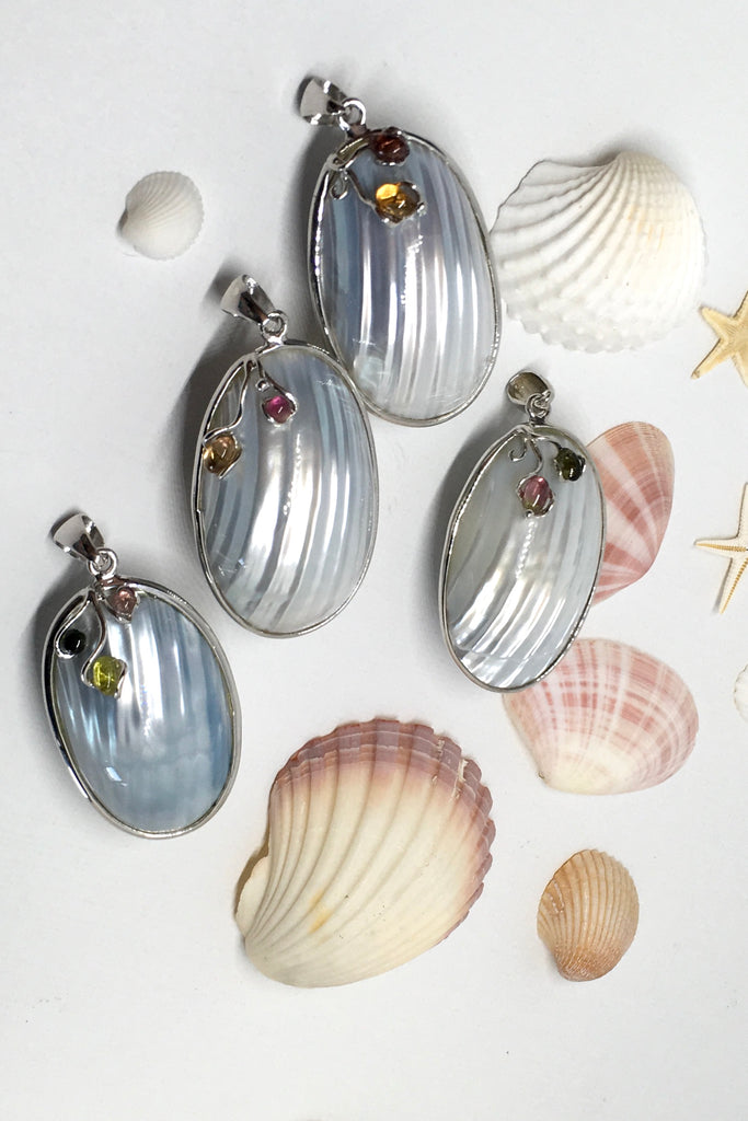 A sweet gentle shell pendant, in pale silvery blue