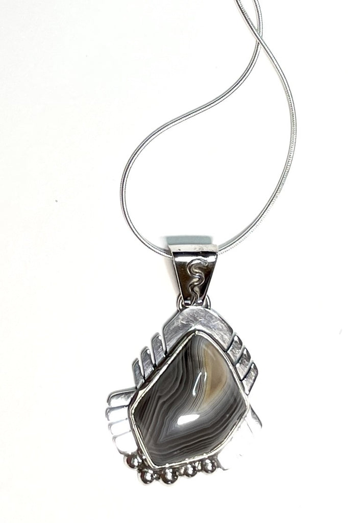 An intriguing powerful and reflecting stone pendant. A modernist pendant in a unique design, the blue Labradorite stone was cut and faceted by a local Sunshine Coast stone artist,